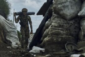 A Ukrainian soldier carries supplies in a trench at the frontline near Bakhmut in the Donetsk region, Ukraine, Monday, May 22, 2023. (AP Photo/Libkos)